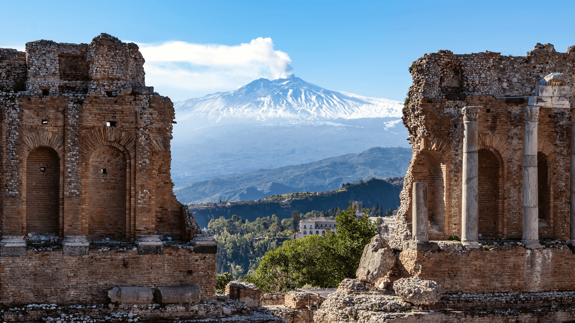 Mount Etna framed by the ruins of the Taormina amphitheatre